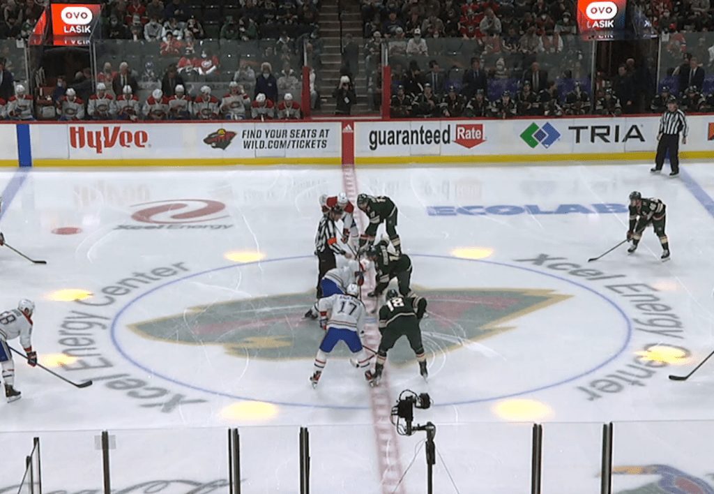 A photo showing a faceoff between two teams during an NHL game.